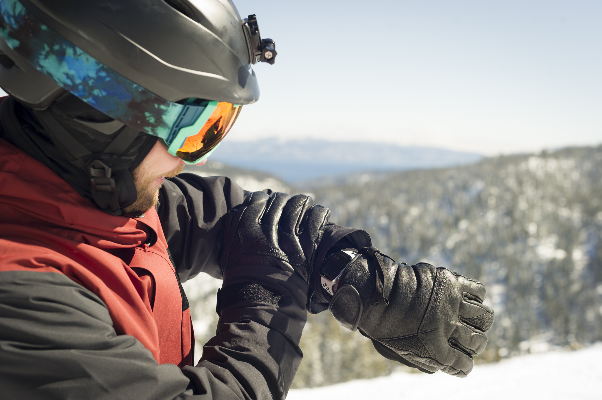 A photo of Slopes founder Curtis Herbert testing out the app on his Watch from the top of a ski slope.