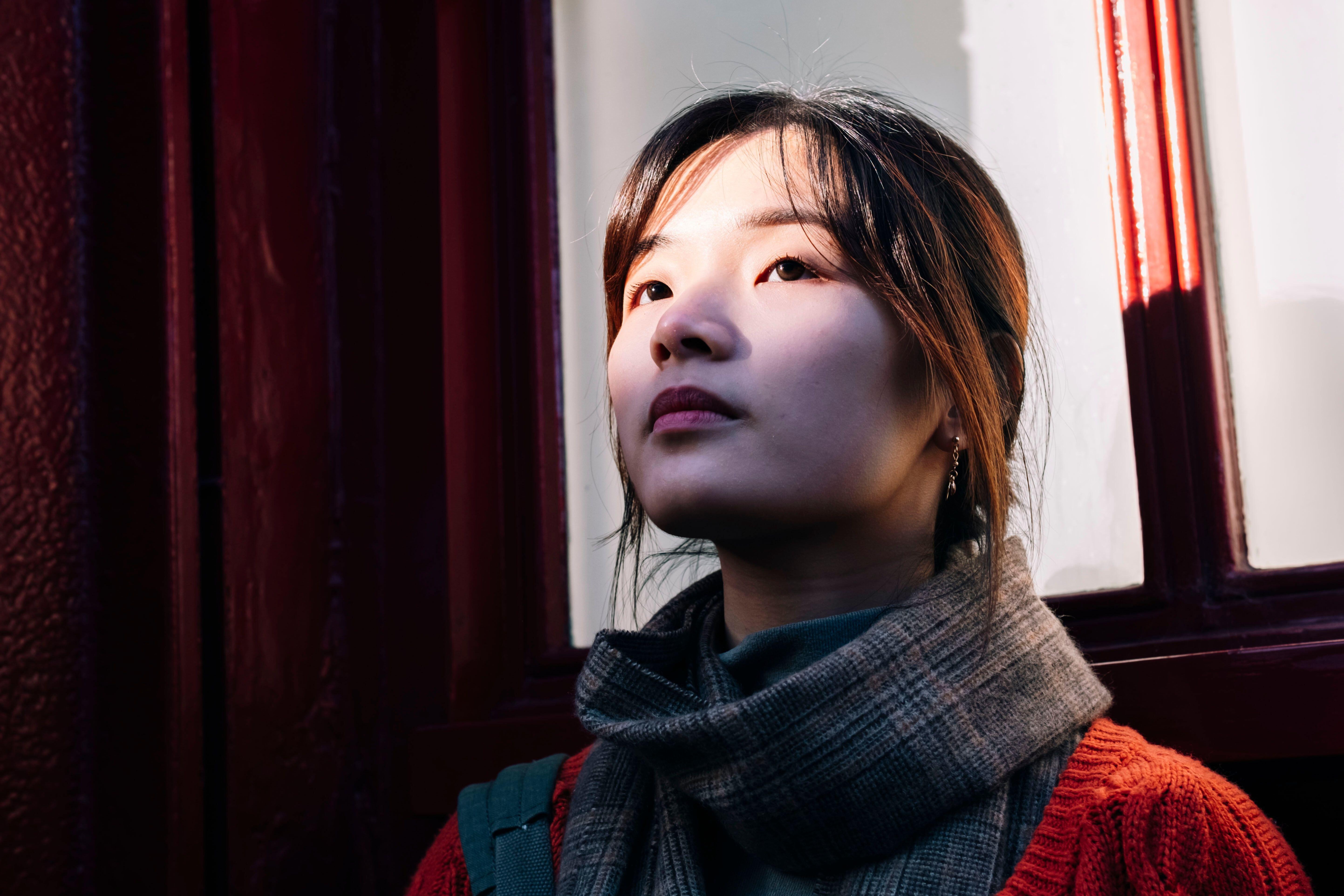 Beautiful woman standing near window