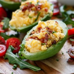 Cheesy Scrambled Eggs in Avocado with Bacon Pieces