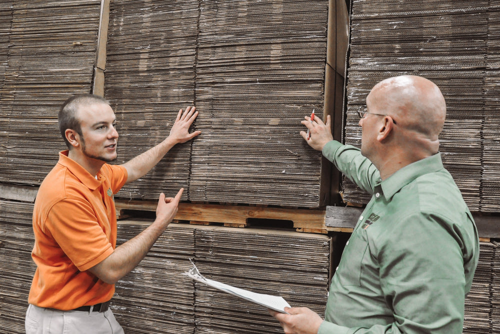 Marty and Zac with pallets of boxes