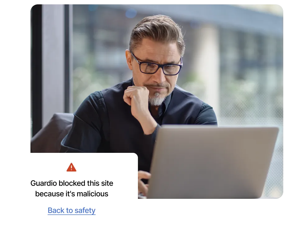 A Guardio user gets an alert about a dangerous website on his laptop