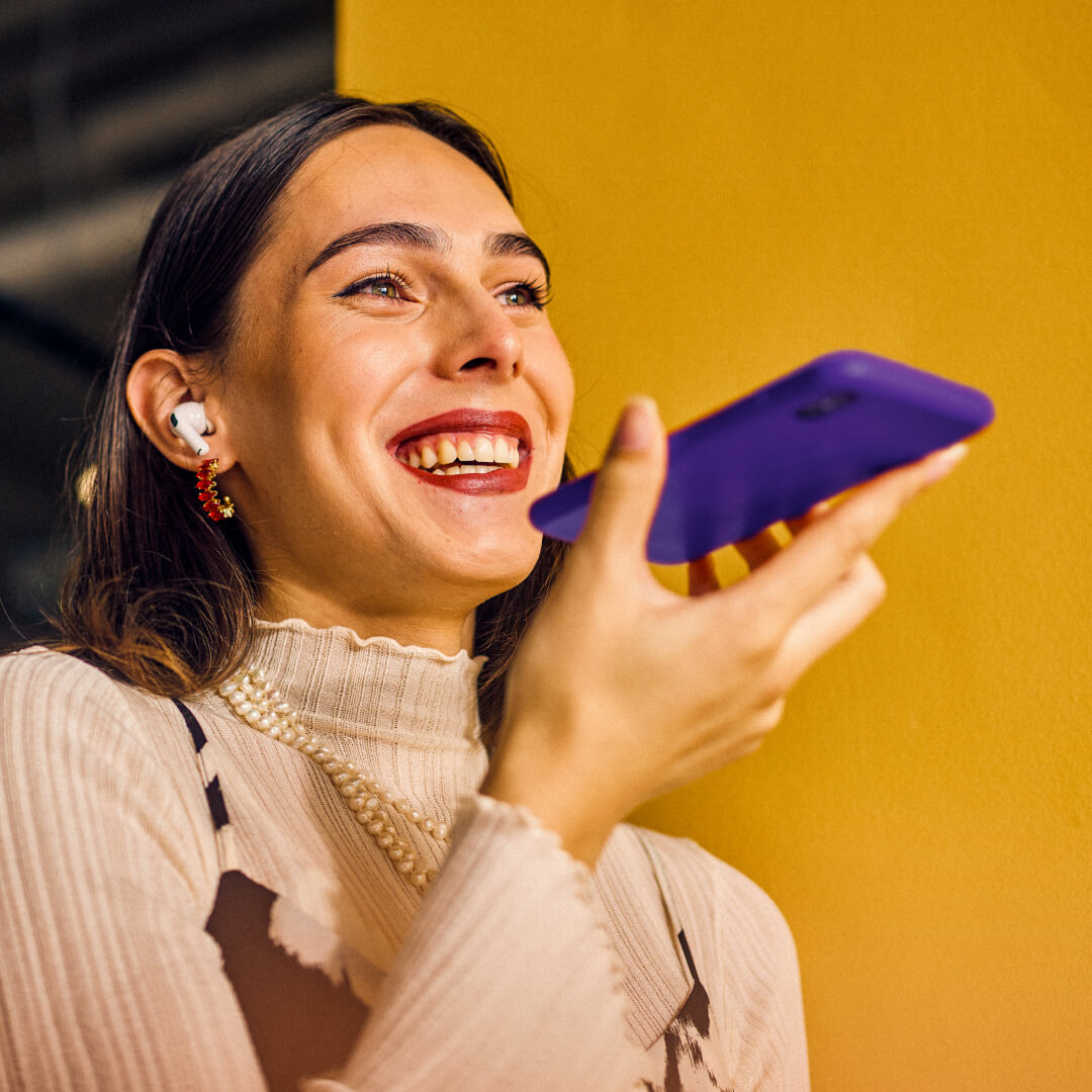 A woman holding a purple phone