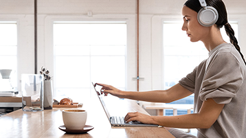 Uma mulher usando o Surface Laptop em uma mesa