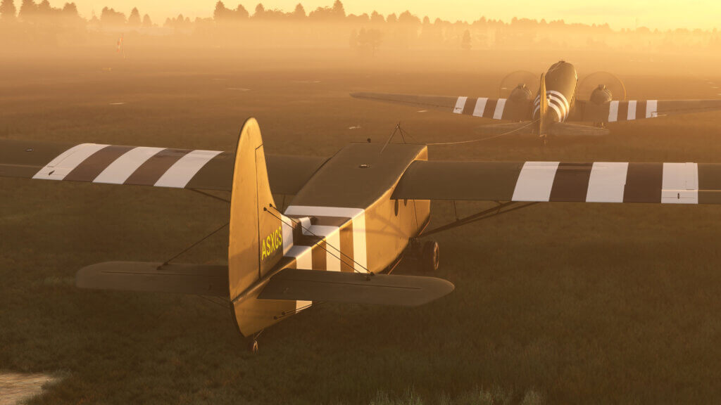 Douglas C-47D Skytrain pulling the Waco CG-4A glider during sunrise