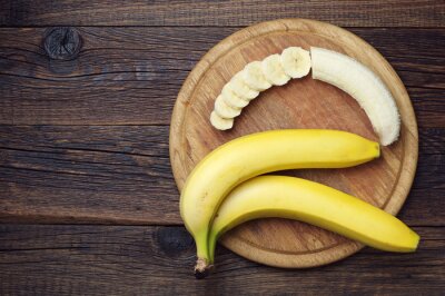 Poster Obst drei Bananen auf Holztablett