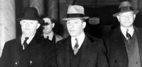 Louis 'Lepke' Buchalter, center, handcuffed to J. Edgar Hoover (left), at entrance to courthouse in New York City in 1939-40. With a $50,000 reward on his head, he was tricked into surrendering to Hoover by a 'friend,' Moey Dimples. Buchalter was executed