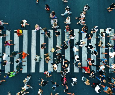 Aerial. People crowd on pedestrian crosswalk. Top view backgroun