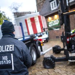 Einsatzkräfte der Polizei stellen Poller zum Schutz des Weihnachtsmarktes auf.