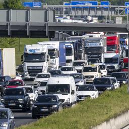 LKW und Autos stauen sich auf einer Autobahn.