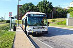 A bus at a stop, seen from the front