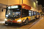 An articulated bus at night