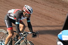 A cyclist riding a bike in a velodrome