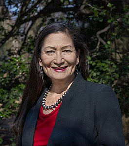 Deb Haaland is from the Laguna Pueblo people and is the first Native American Cabinet Secretary as Secretary of Interior. Her father is Norwegian-American.[64]