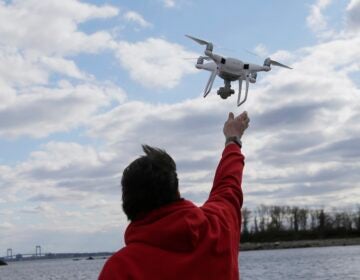 a man flyes a drone in New York