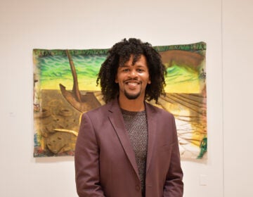 Dr. Matthew Jordan-Miller Kenyatta (Dr. Matt) in the Edgar Heap of Birds Family Gallery, the main exhibitions space for Temple Contemporary. (Ryan Mercado/WHYY)