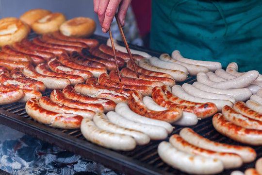 rows of bratwurst on a large grill