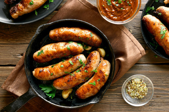 Fried sausages in frying pan