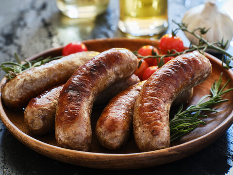 plate of german bratwurst sausages with herbs