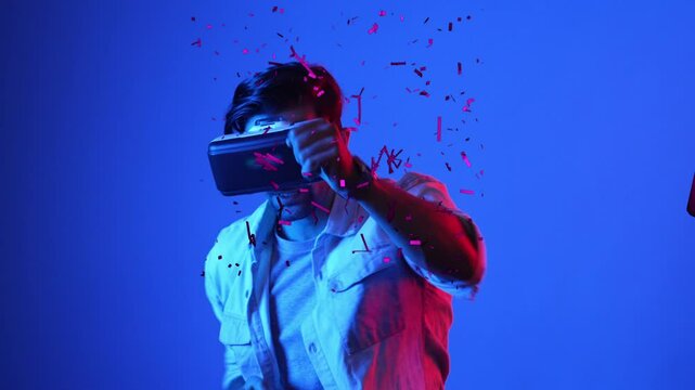 Skilled gamer boxing and punching floating box while wearing VR glasses to connect metaverse. Male model using virtual reality goggles while exercising and standing at neon background. Apparatus.