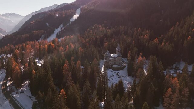 Snow blankets Castel Savoia in winter, captured by drone, highlighting its timeless beauty amidst the alpine serenity of Gressoney.