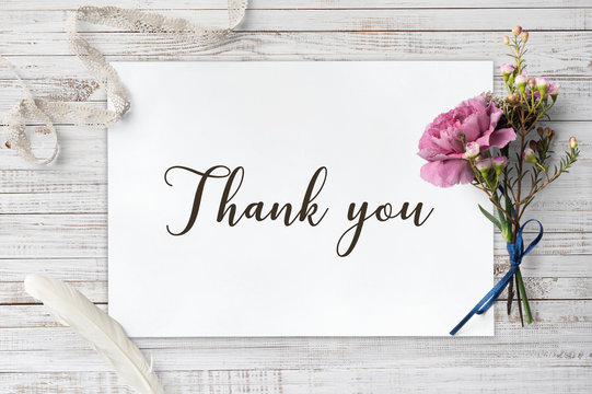 
Thank you - calligraphy on white paper with decorative items