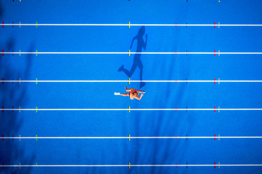 Top view of female runner on tartan track