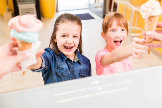 Kinder bekommen ihr Eis in der Eisdiele