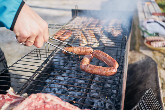 preparation of barbecue on bacon and sausage grill