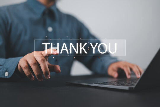 businessman using a laptop and touching the message thank you on a display screen. concept of thank you business, congratulations, and appreciation gratitude. presentation from technology digital