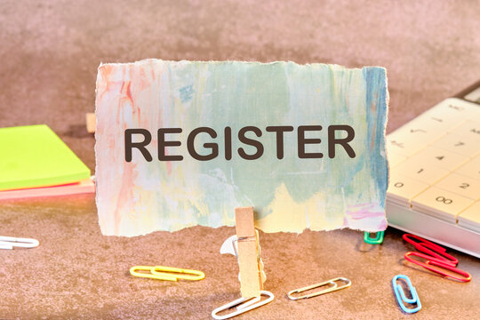 Conceptual register symbol. Copy space. Register written on a piece of paper in a clothespin