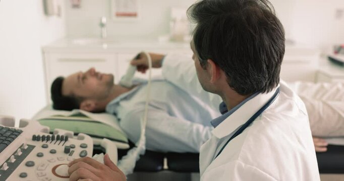 Close up of mature Hispanic male endocrinologist doc check man patient thyroid gland nodules using modern ultrasonography equipment, scanning, review endocrine system. Preventive medicine, insurance