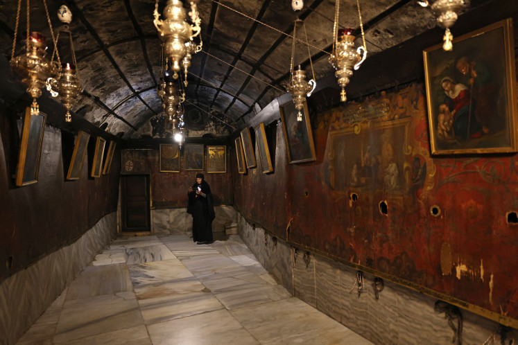 A  Christian worshipper visits the Church of the Nativity on Dec. 17, 2024, in the biblical city of Bethlehem, in the occupied West Bank.