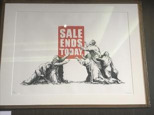 A print of four apostles worshipping a 'Sale Ends Today sign i n red and white by Banksy.