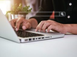 hands typing on laptop