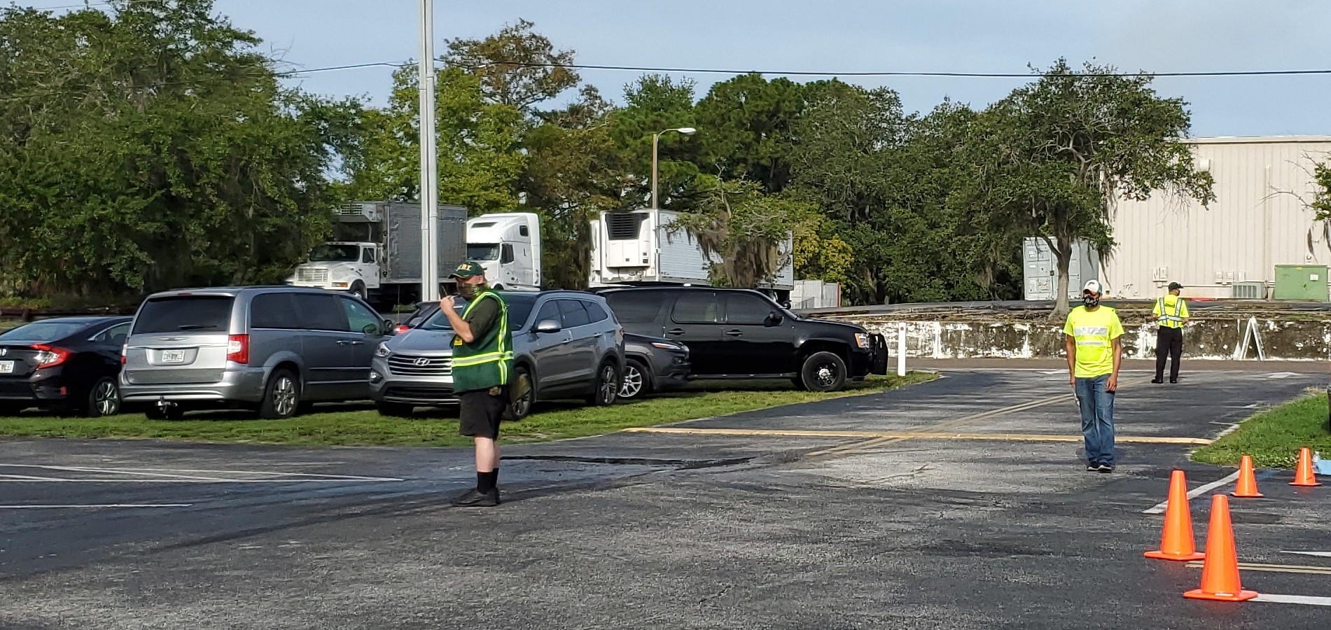 Photo of a man with a CERT jacket on directs traffic.