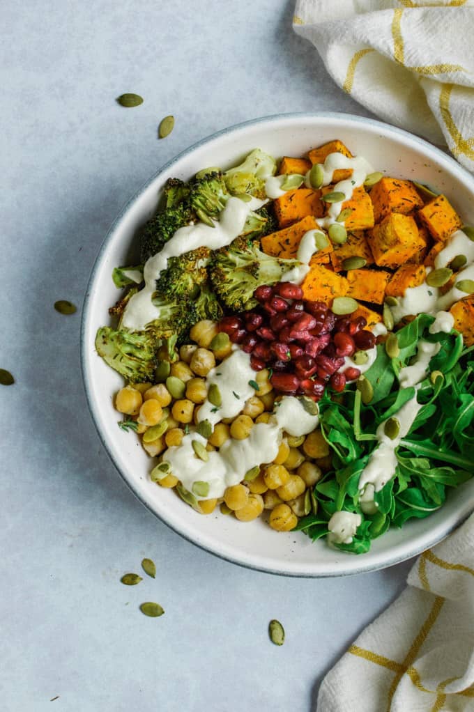 Vegetable Harvest Bowl on a concrete counter top with pumpkin seeds on the side 