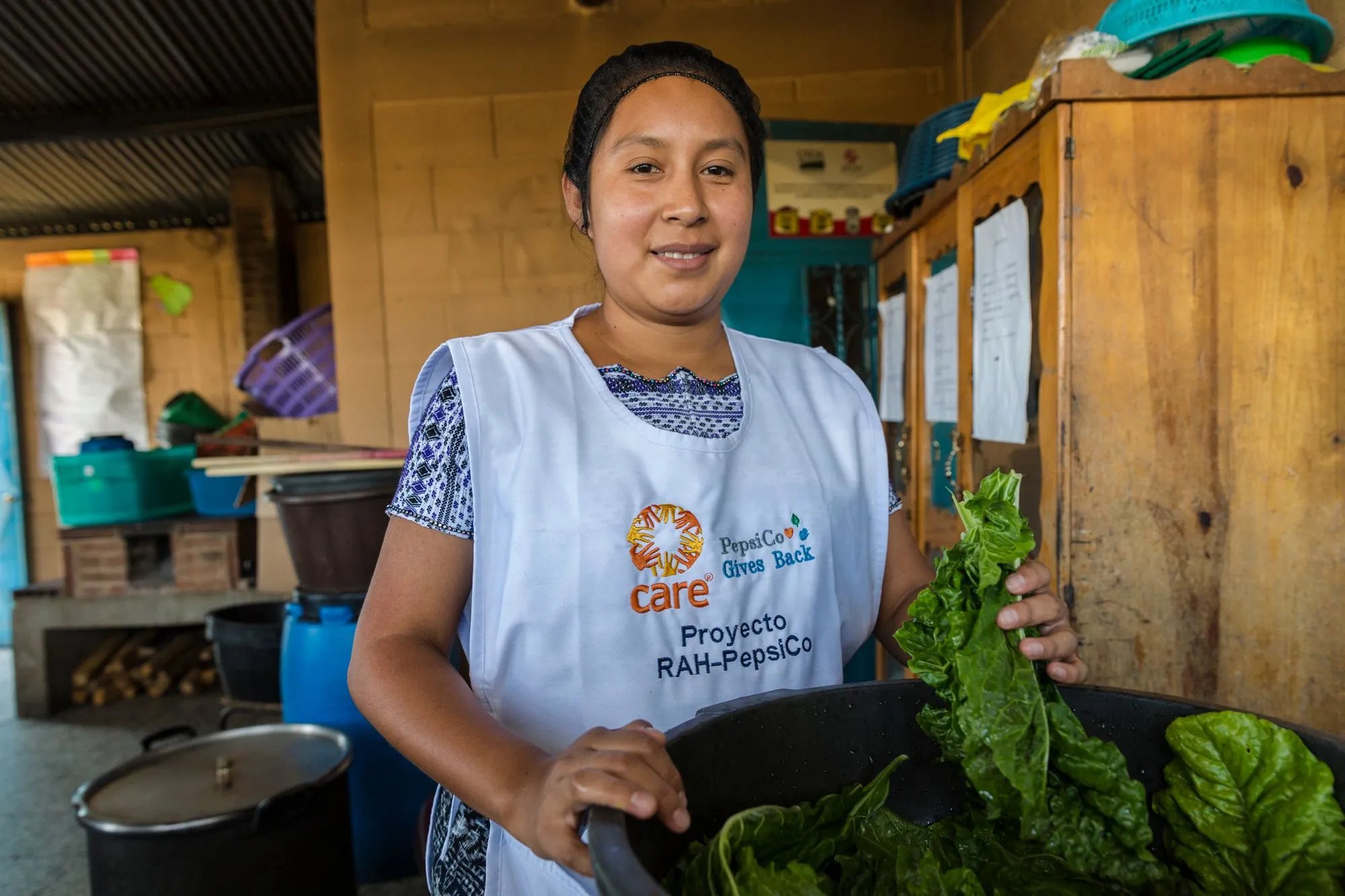 A woman wearing a white apron that says 