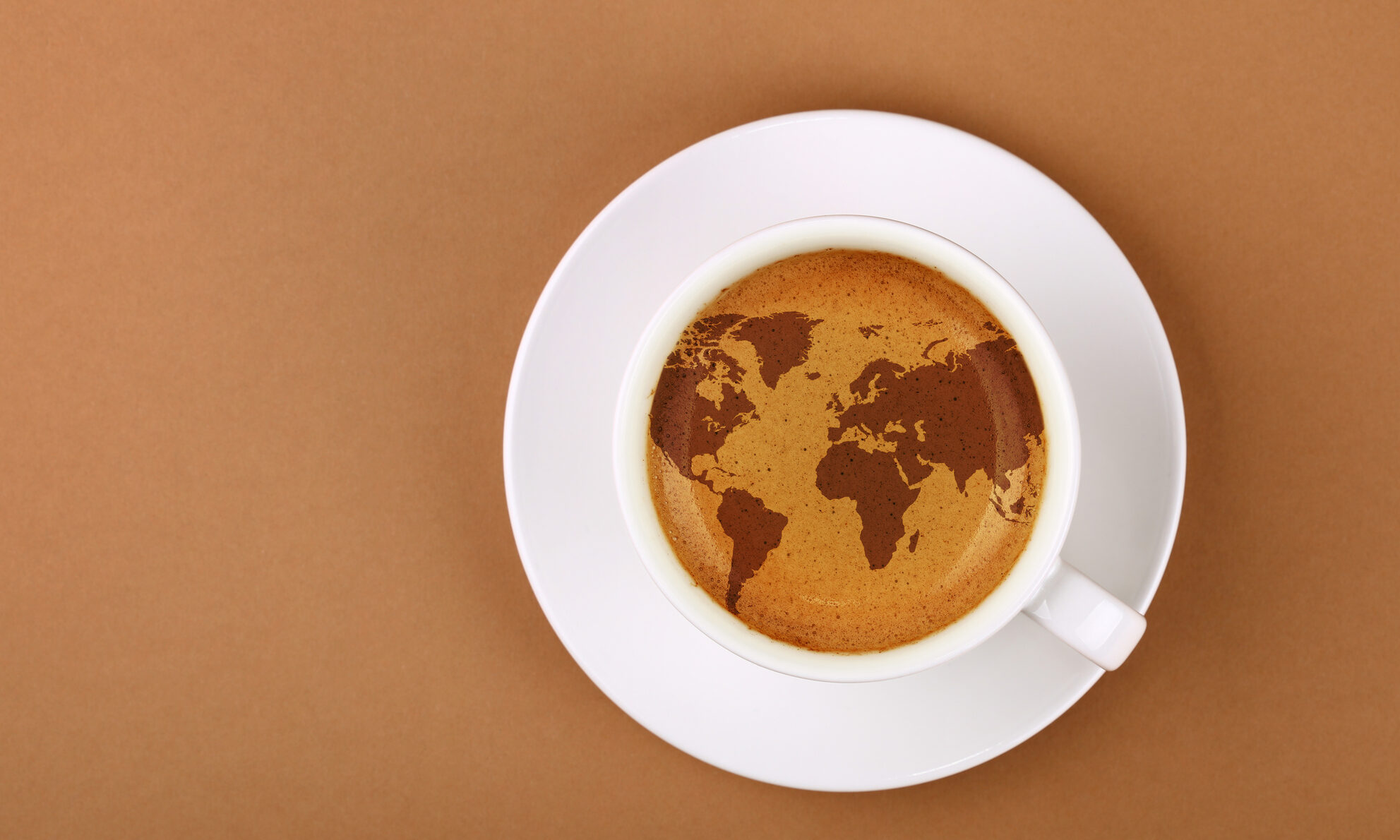 Espresso coffee cup with world map on table