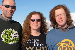 Three people wearing t shirts with writing on them