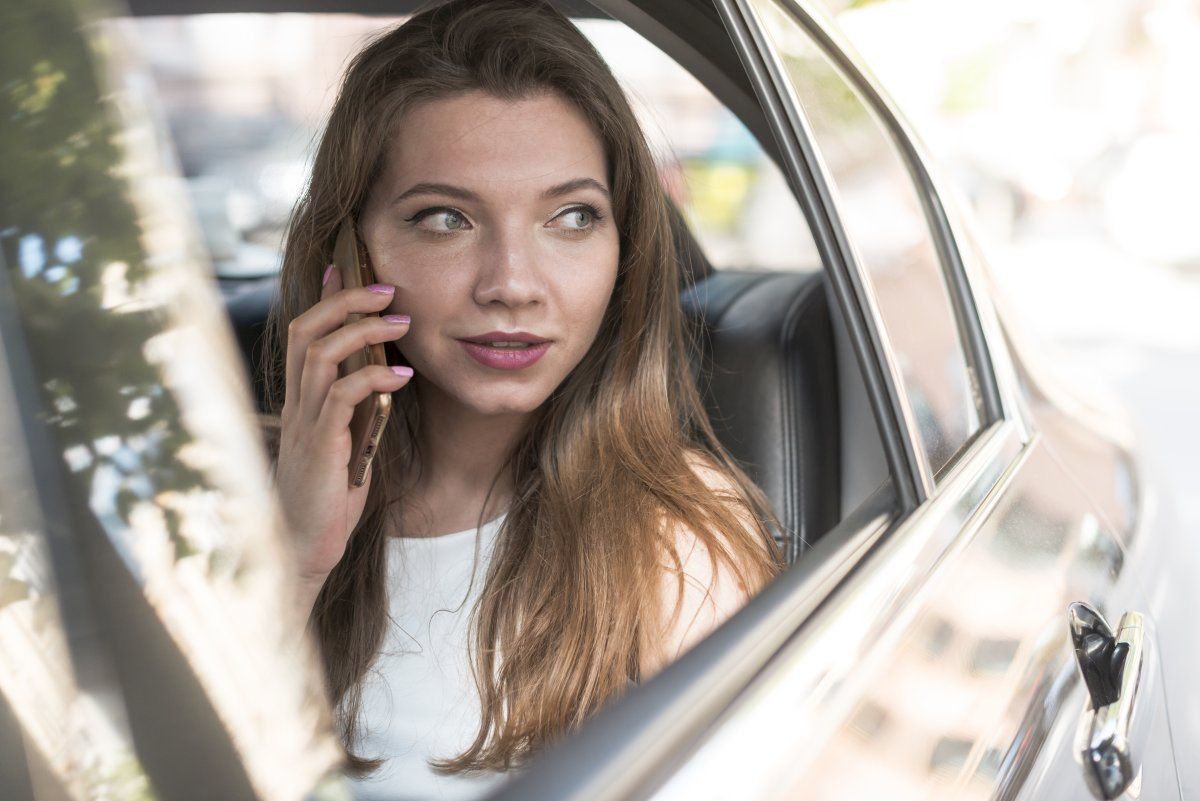 business woman posing inside car