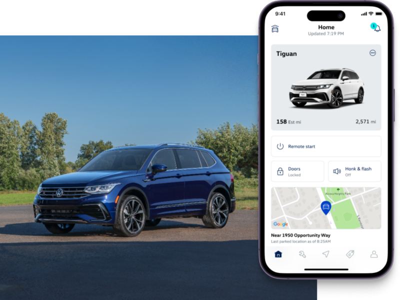 Tiguan shown in Atlantic Blue Metallic parked in a grassy, tree filled park setting. To the right, the MyVW app interface is displayed on a compatible phone.