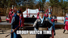 a group of soldiers are standing in front of a tent with the words group watch time on the bottom