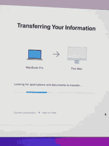 a screen that says transferring your information with a laptop and a monitor