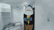 a stuffed shark is standing in a kitchen wearing a suit and tie