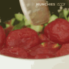 a close up of a bowl of tomatoes with the words munchies vice written on the bottom