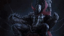 spawn is sitting on a throne with chains around his feet .