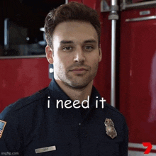 a man in a fireman 's uniform is standing in front of a red truck and says i need it