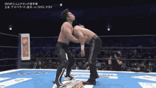 two men are wrestling in a ring with the words iwgp on the bottom