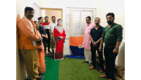 a group of people stand in front of a cardboard cutout of a woman