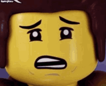 a close up of a lego figure 's face with a surprised expression .